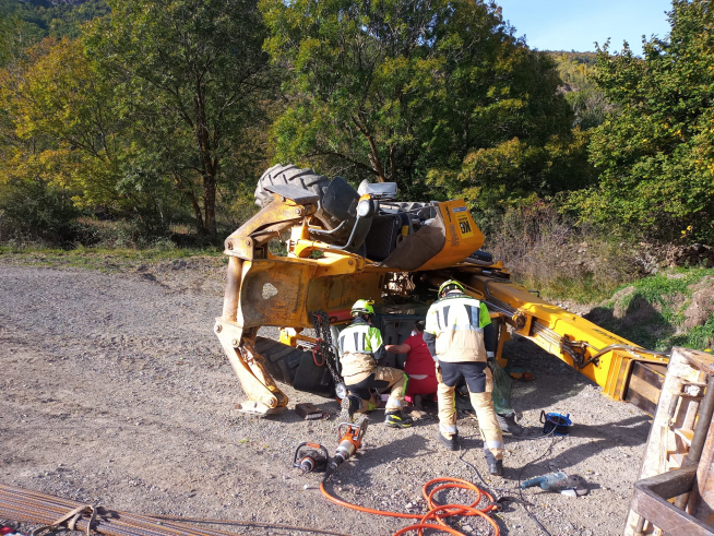 Labores de rescate del trabajador atrapado bajo la excavadora en Benasque.