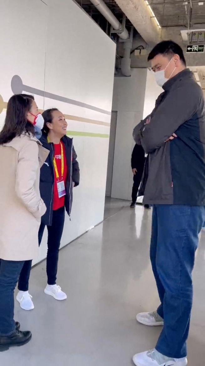 Chinese tennis player Peng Shuai talks with former NBA basketball player Yao Ming at an event in Shanghai
