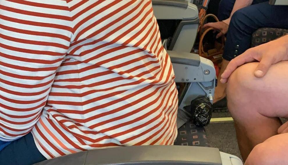 La imagen muestra a una mujer en un asiento sin respaldo en un vuelo de EasyJet.