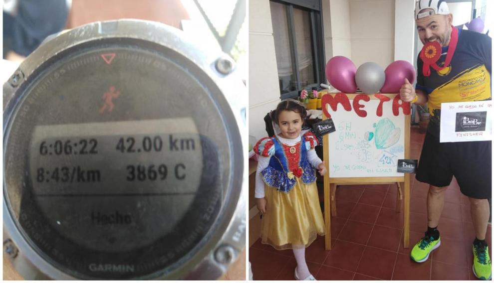 Jesús Nuño con su hija tras completar 42 kilómetros en el pasillo de su casa.