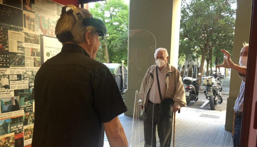 Paco Goyanes saluda a dos clientes.