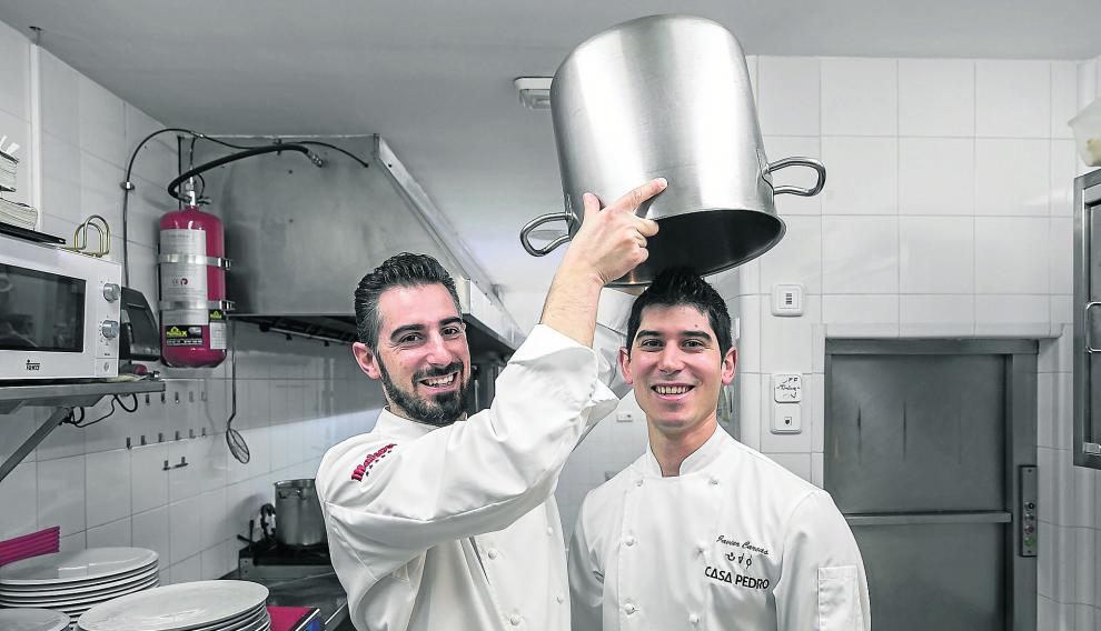 Luis Carcas izqda. bromea con su hermano Javier en las cocinas de Casa Pedro, su restaurante en Zaragoza.