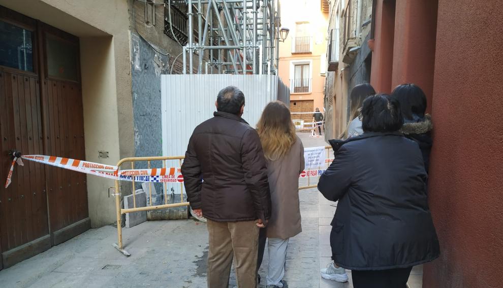 La familia afectada, junto a unas sobrinas, observa su vivienda derrumbada.