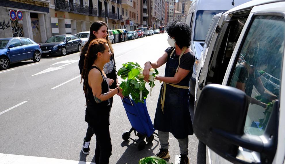 Nieves, Nato, y Lucía, vecinas del barrio de la Madalena que se han organizado para repartir verdura fresca.