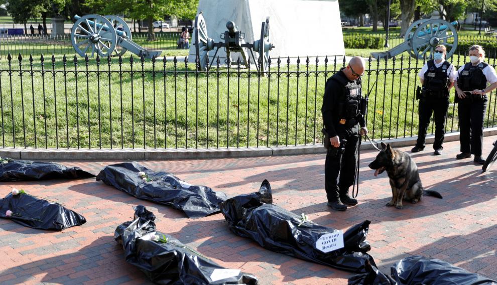 Protestors hold a funeral procession demonstration for the coronavirus disease (COVID-19) victims outside of the White House in Washington