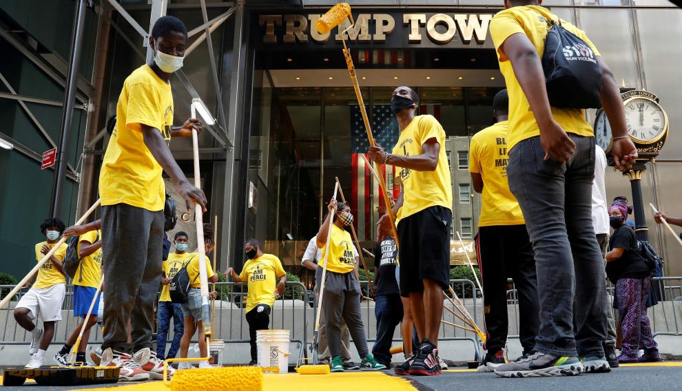 People paint a "Black Lives Matter" along 5th avenue outside Trump Tower in New York City