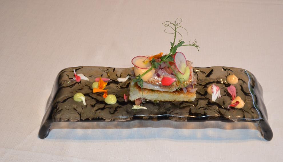 Tostada de salmonete ahumado con crema de aguacate, pico de gallo y chile chipotle.