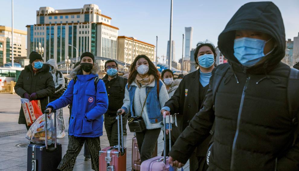 Travellers push suitcases outside Beijing Railway Station following an outbreak of the coronavirus disease (COVID-19) in Beijing