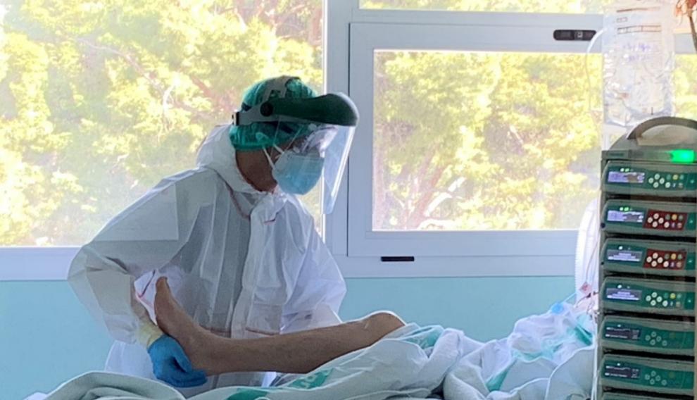 El fisioterapeuta Antonio Miguel, con un paciente ingresado en la uci del Servet.