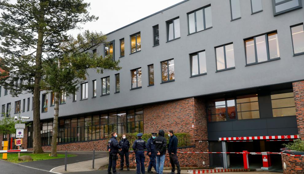 Police officers stand near the Oberlin Clinic, where dead and injured people were found, in Potsdam