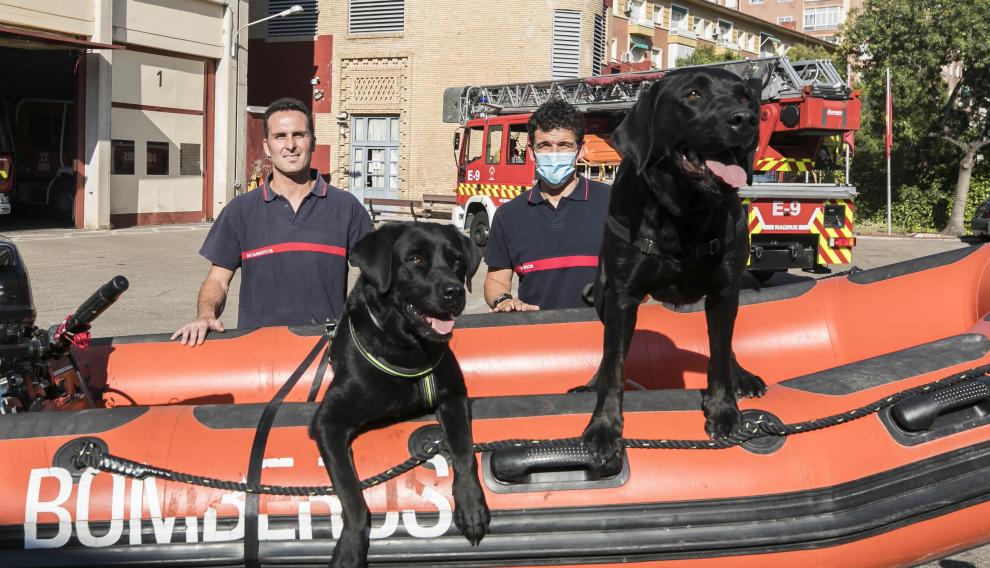 Rubén Merendiano y Pablo Monsalve con sus perras Kumba e India en el parque de Bomberos número 3 de Zaragoza.