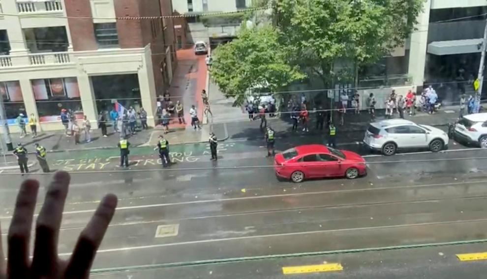 Djokovic supporters stand outside Park Hotel in Melbourne