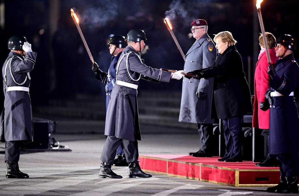 German Chancellor Angela Merkel reacts as she departs from the defence ministry after the Grand Tattoo (Grosser Zapfenstreich), a ceremonial send-off for her in Berlin, Germany December 2, 2021. Odd Andersen/Pool via REUTERS GERMANY-MERKEL/CEREMONY