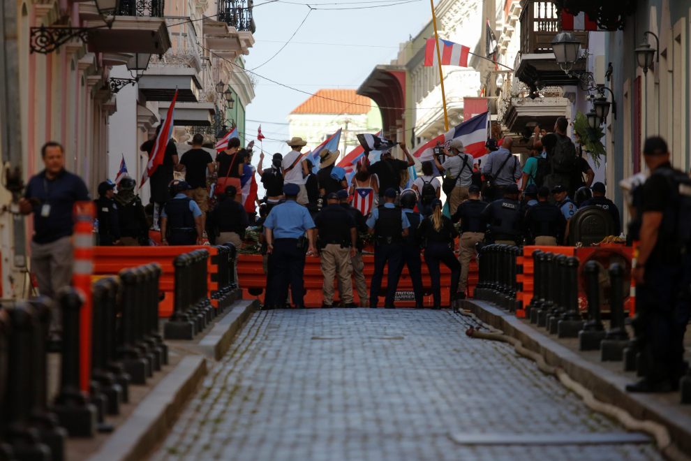 U.S. and Puerto Rican flags fly at top of La Fortaleza, the official residence of the Governor of Puerto Rico, in Old San Juan, Puerto Rico July 24, 2019. REUTERS/Marco Bello [[[REUTERS VOCENTO]]] USA-PUERTORICO/