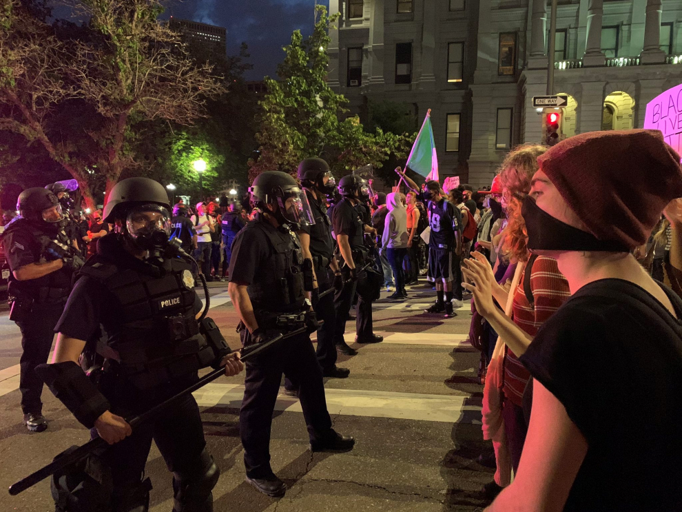 Demonstrators face off with police near Capitol building in Denver, Colorado