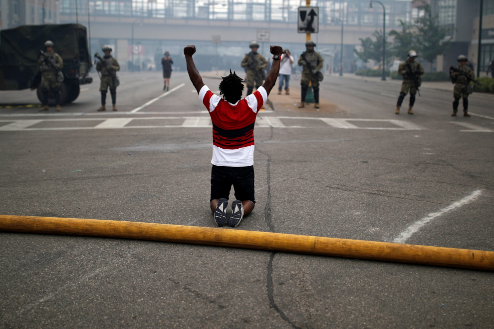 Man reacts as he confronts National Guard members guarding the area in the aftermath of a protest, in Minneapolis