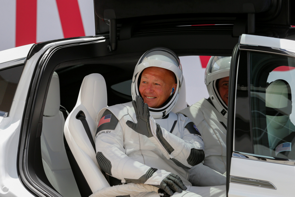 NASA astronaut Douglas Hurley waves as he heads to Pad39A before the launch of a SpaceX Falcon 9 rocket and Crew Dragon spacecraft at the Kennedy Space Center, in Cape Canavera