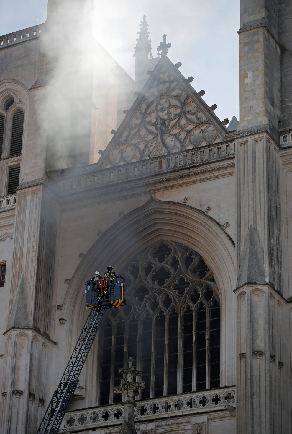 French firefighters gather at the scene of a blaze at the Cathedral of Saint Pierre and Saint Paul in Nantes, France, July 18, 2020. REUTERS/Stephane Mahe [[[REUTERS VOCENTO]]] FRANCE-FIRE/NANTES-CATHEDRAL