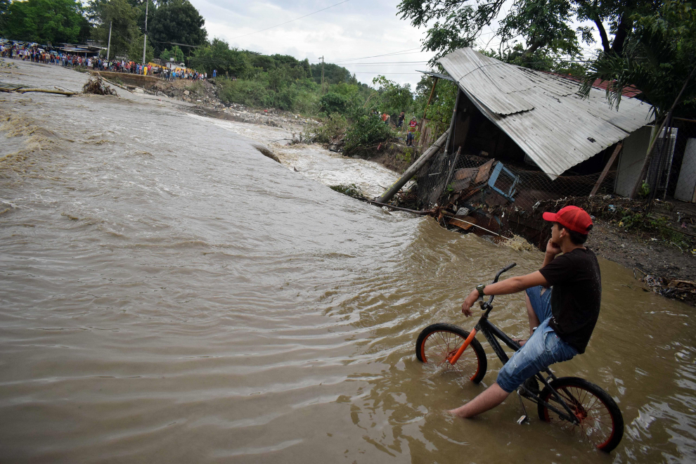 A child pushes his bicycle through a flooded road after the passing of Storm Iota, in Marcovia, Honduras November 18, 2020. REUTERS/Jorge Cabrera[[[REUTERS VOCENTO]]] STORM-IOTA/