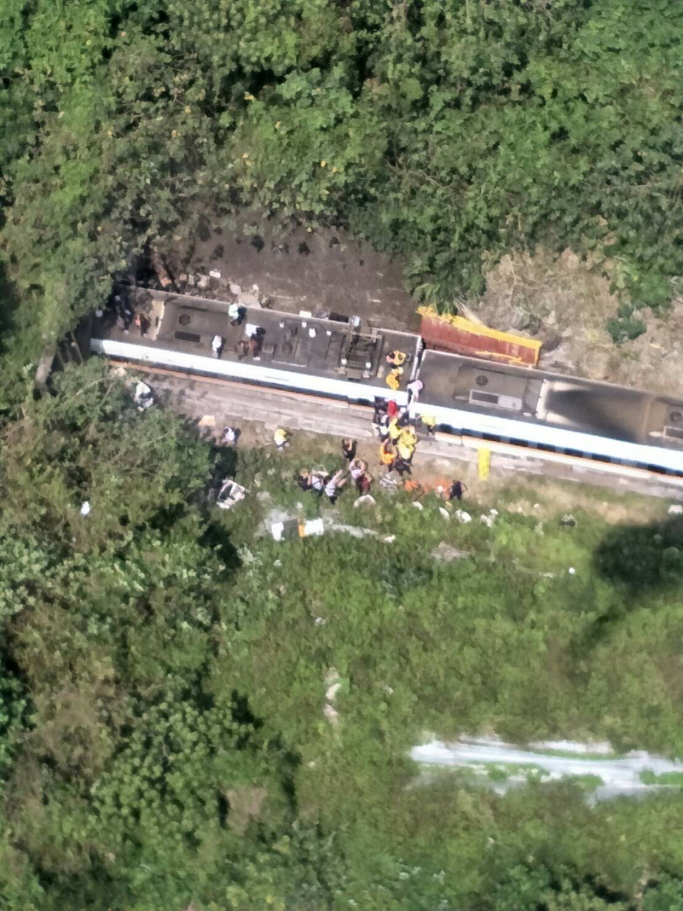 Rescue workers are seen by a train which derailed in a tunnel north of Hualien
