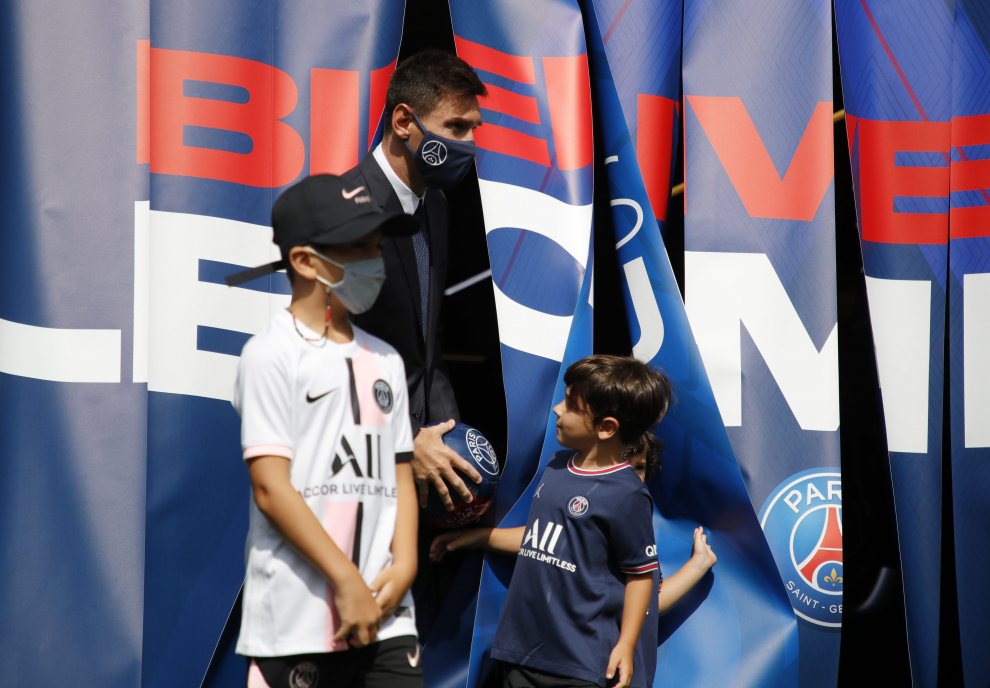 Soccer Football - Lionel Messi Press Conference after signing for Paris St Germain - Parc des Princes, Paris, France - August 11, 2021 Paris St Germains Lionel Messi and president Nasser Al-Khelaifi pose with children on the pitch after the press conference REUTERS/Sarah Meyssonnier[[[REUTERS VOCENTO]]] SOCCER-MESSI/