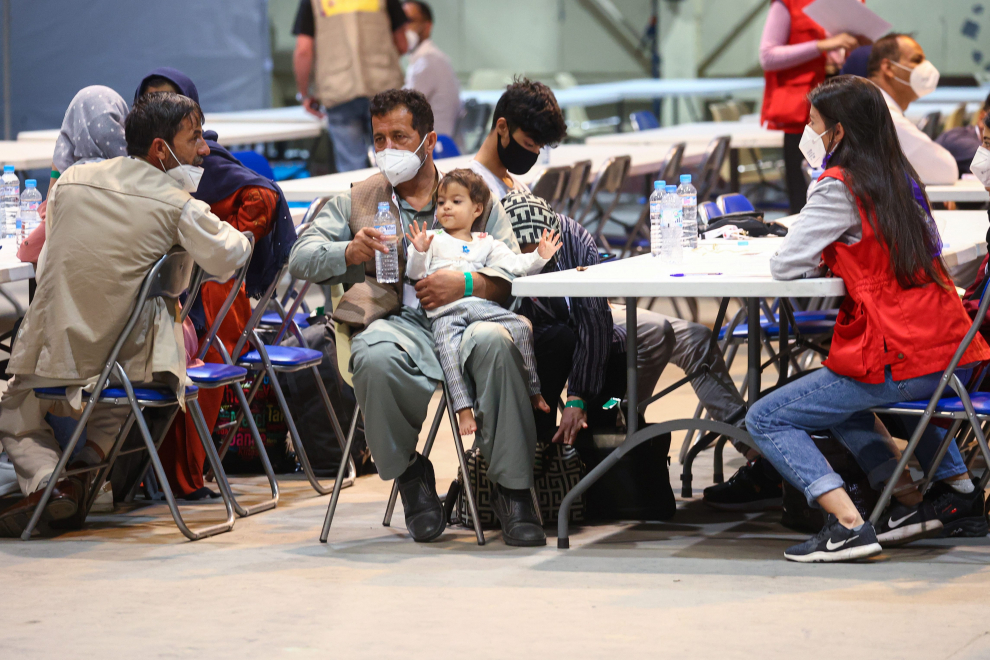 Spanish and Afghan citizens rest after their arrival at Torrejon airbase after evacuating from Kabul, in Torrejon de Ardoz, outside Madrid, August 19, 2021. REUTERS/Juan Medina[[[REUTERS VOCENTO]]] AFGHANISTAN-CONFLICT/SPAIN