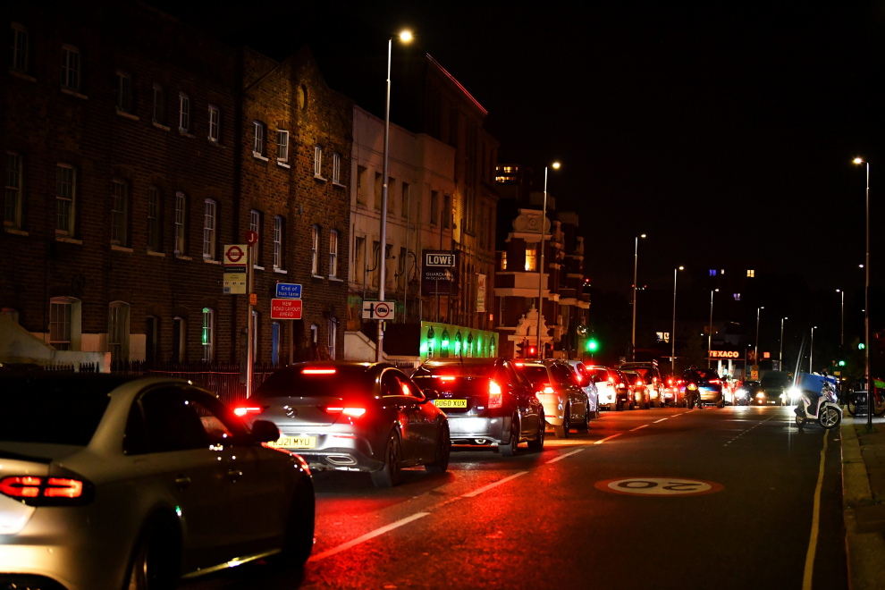 People wait outside their cars as vehicles queue to refill at a Texaco fuel station in south London, Britain, September 26, 2021. Picture taken September 26, 2021.  REUTERS/Dylan Martinez[[[REUTERS VOCENTO]]] POWER-PRICES/BRITAIN