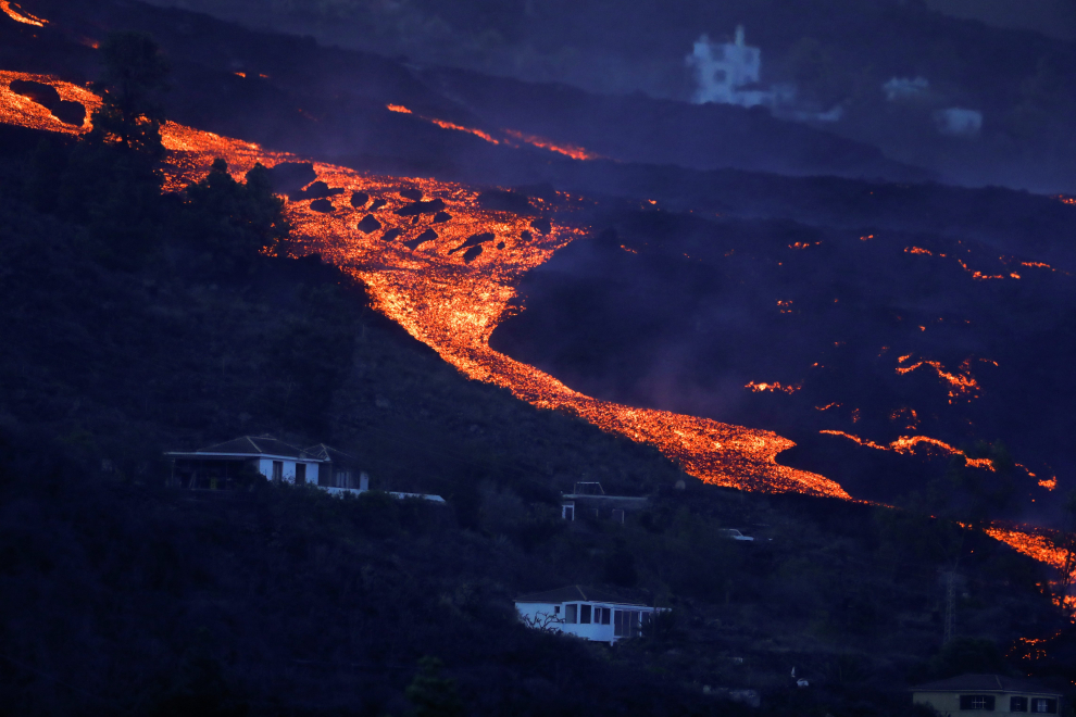 Lava from the Cumbre Vieja volcano burns a house on the Canary Island of La Palma, as seen from Tajuya, Spain, October 19, 2021. REUTERS/Susana Vera[[[REUTERS VOCENTO]]] SPAIN-VOLCANO/