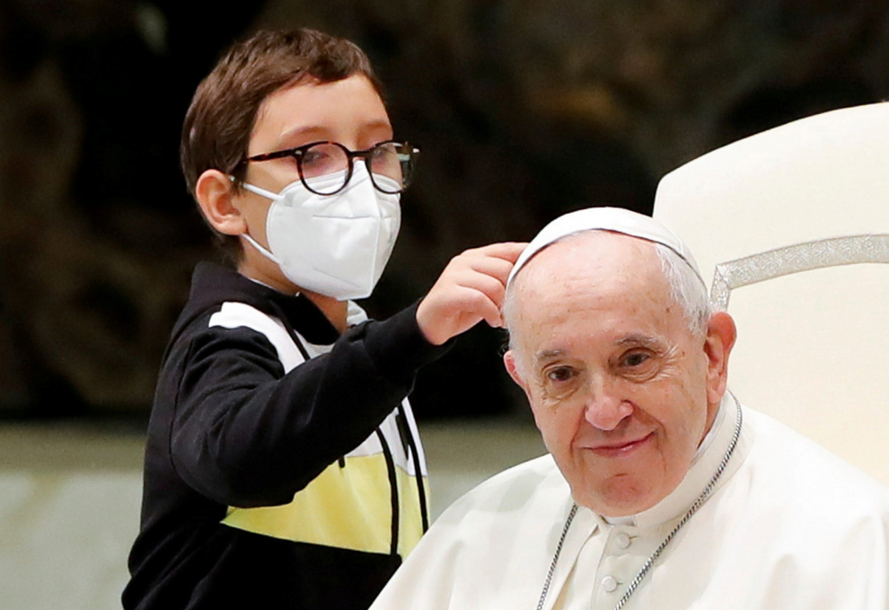 Pope Francis embraces a boy after the weekly general audience at the Vatican, October 20, 2021. REUTERS/Remo Casilli[[[REUTERS VOCENTO]]] POPE-AUDIENCE/BOY