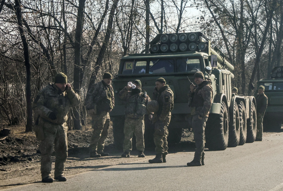 Ukrainian army soldier are seen next to multiple launch missile systems in Kharkiv region