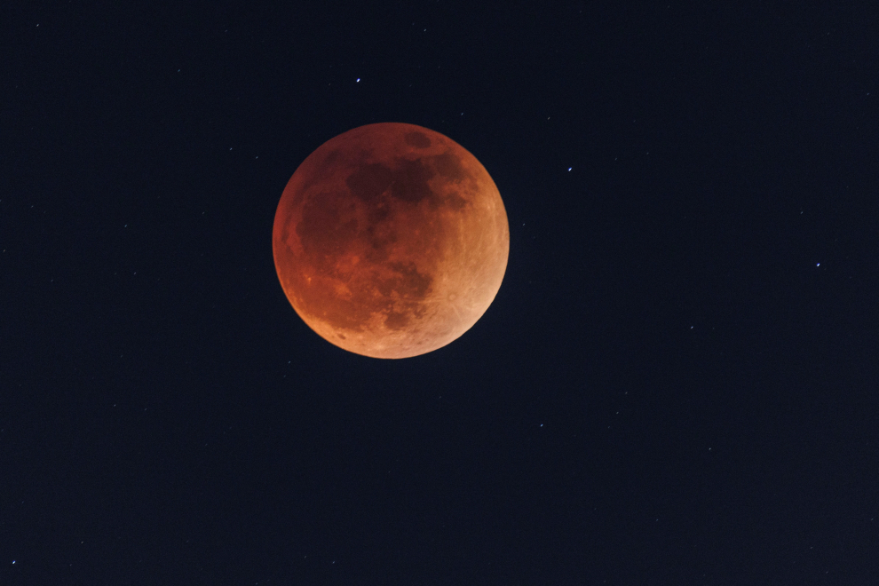 A full moon moves through the shadow of the earth during a "Blood Moon" lunar eclipse in San Diego
