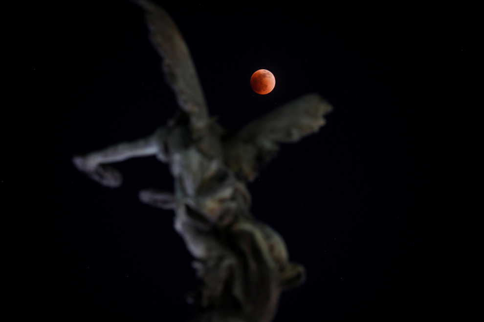 A full moon moves through the shadow of the earth during a "Blood Moon" lunar eclipse in San Salvador