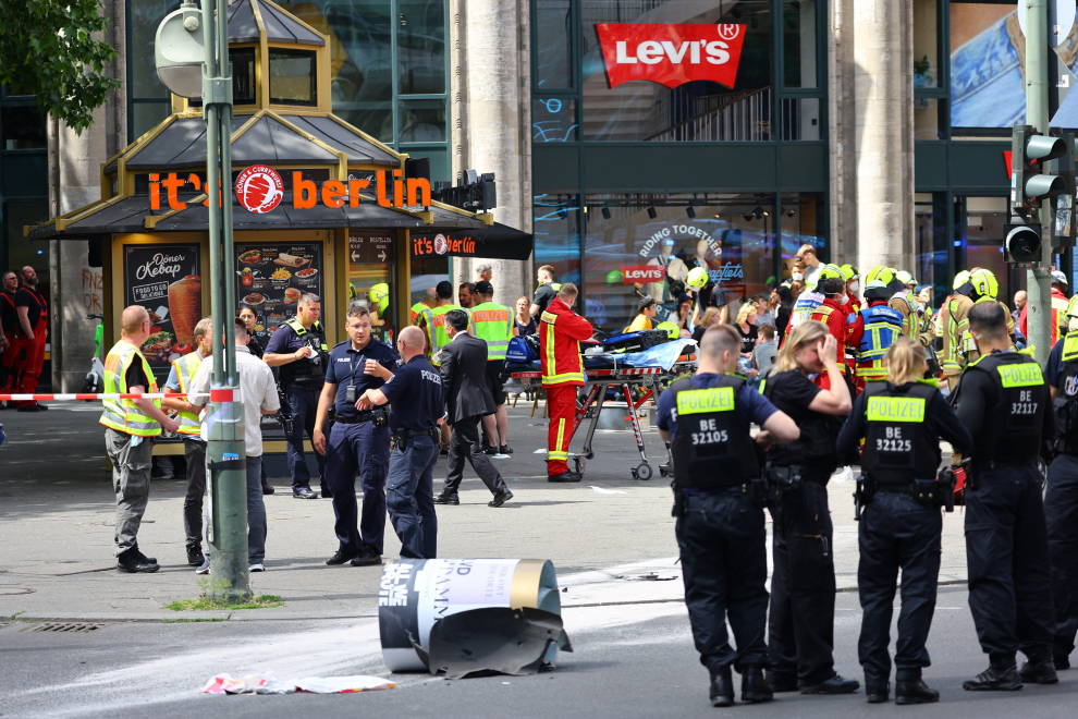 A first responder works near the car at crashed into a group of people, injuring dozens of others and killing at least one, at Tauentzien Strasse near Kaiser Wilhelm Gedaedtniskirche church in Berlin, Germany June 8, 2022. REUTERS/Fabrizio Bensch GERMANY-CRASH/