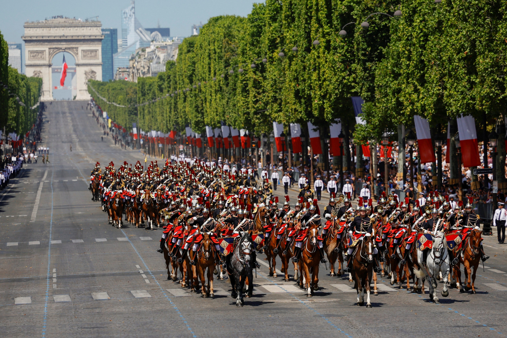 Troops drive in vehicles down the Champs-Elysees avenue during the annual Bastille Day military parade in Paris, France, July 14, 2022. REUTERS/Sarah Meyssonnier FRANCE-NATIONALDAY/PARADE