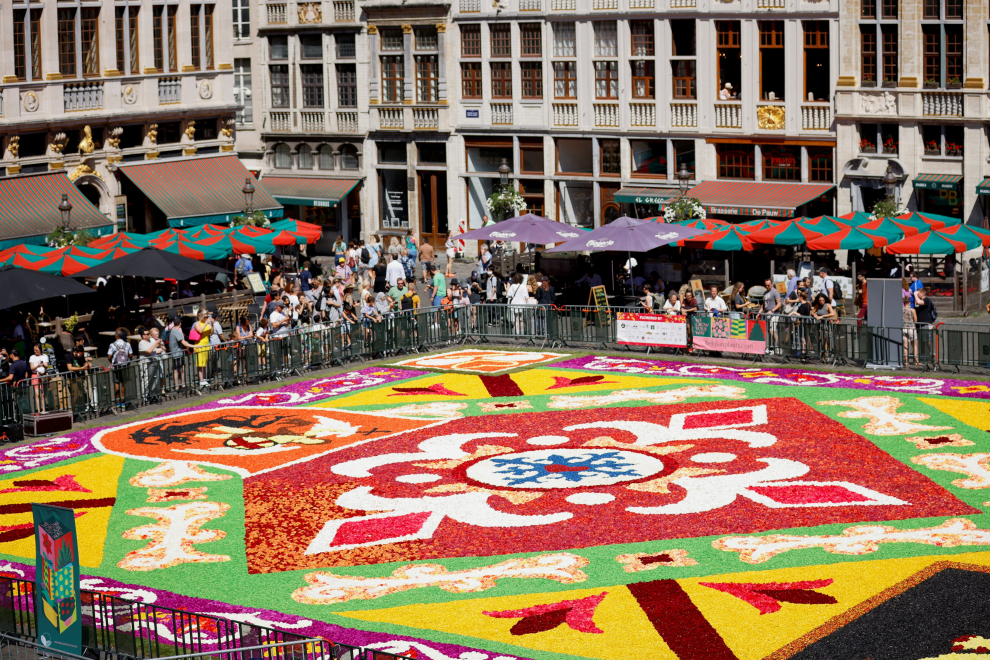 A gardener adjusts flowers on a 1,680 square meters flower carpet made with Belgian begonias, dahlias, grasses, barks and chrysanthemums, at Brussels Grand Place, Belgium, August 12, 2022. REUTERS/Johanna Geron BELGIUM-FLOWERS/