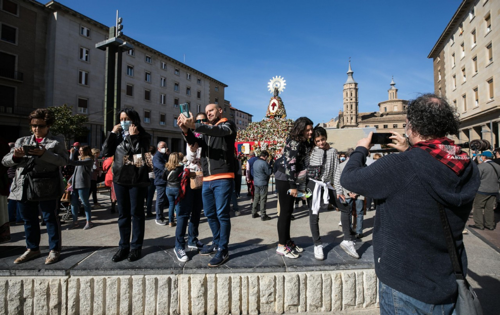 Zaragozanos y visitantes acuden a la plaza del Pilar para ver el manto de la Virgen.