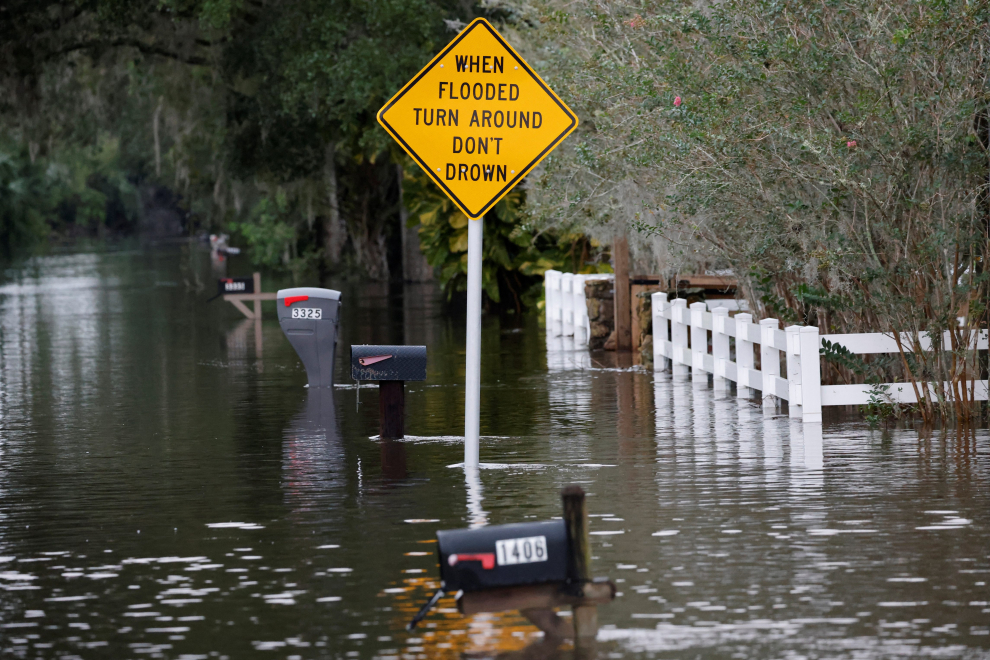 A partially submerged car and home are shown after Hurricane Ian caused widespread damage and flooding in Kissimmee, Florida, U.S., September 29, 2022.  REUTERS/Joe Skipper STORM-IAN/FLORIDA