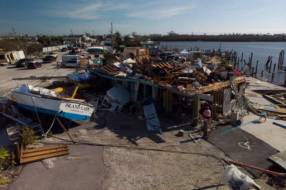A damaged yatch sits on top of a car after Hurricane Ian caused widespread destruction in Fort Myers Beach, Florida, U.S., September 29, 2022. REUTERS/Marco Bello STORM-IAN/FLORIDA