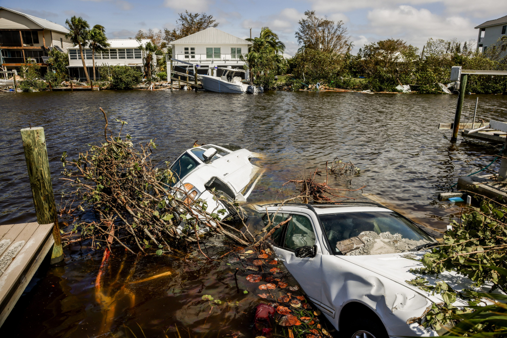 People walk amid flood water after Hurricane Ian caused widespread damage and flooding in Orlando, Florida, U.S., September 29, 2022. REUTERS/Joe Skipper STORM-IAN/FLORIDA