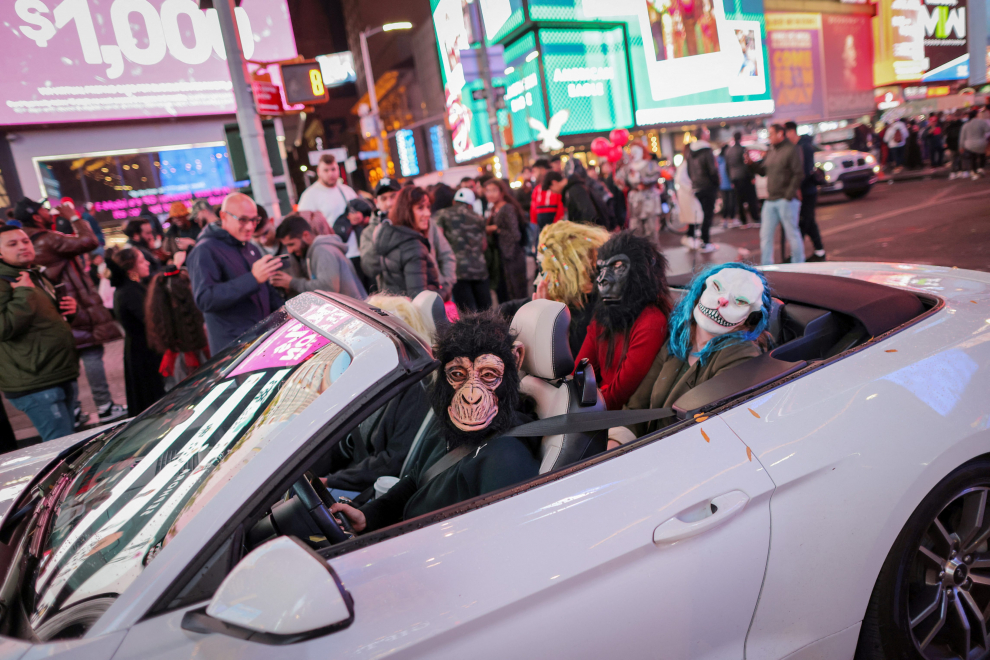 A person dressed as Beetlejuice sits on a vehicle in Times Square on Halloween in Manhattan, New York City, U.S., October 31, 2022.  REUTERS/Andrew Kelly HALLOWEEN-DAY/NEW YORK