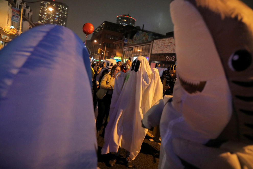 Carlos Guerrero poses for a photo in his Joker costume during Church Street's annual Halloween party in Toronto, Ontario, Canada October 31, 2022. REUTERS/Nick Lachance HALLOWEEN-DAY/CANADA