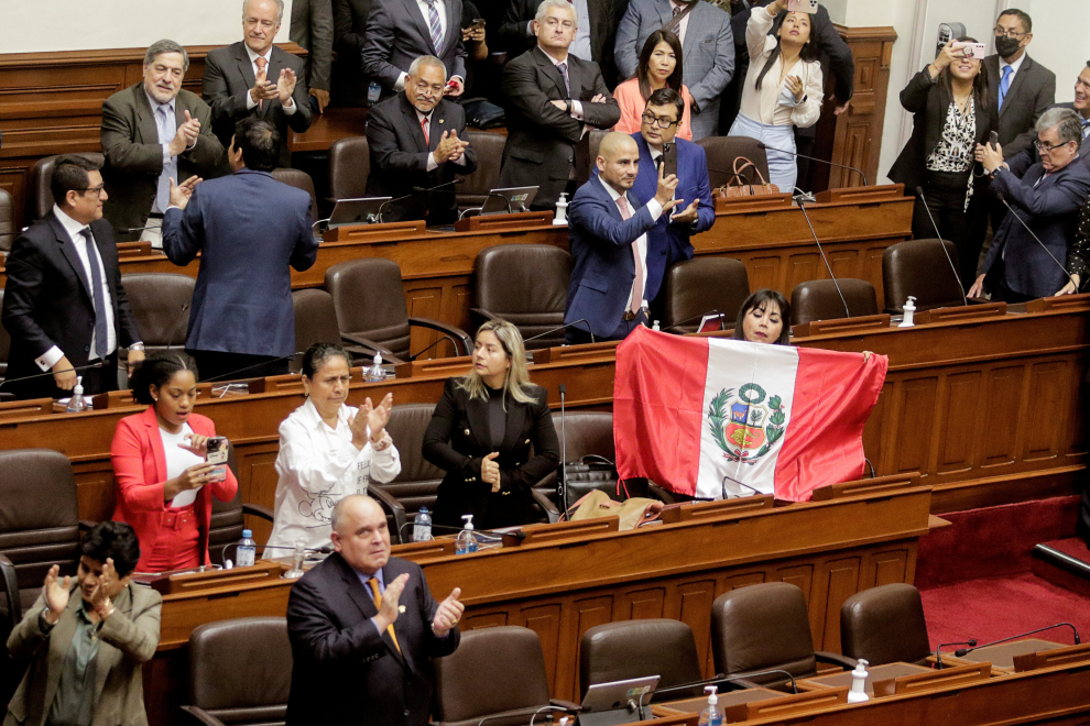 A member of Peru's Congress displays a Peruvian flag after Congress approved the removal of President Pedro Castillo, in Lima, Peru December 7, 2022. REUTERS/Sebastian Castaneda PERU-POLITICS/CASTILLO