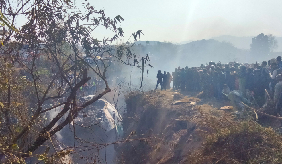 Crowd gather at the crash site of an aircraft carrying 72 people in Pokhara in western Nepal January 15, 2023. Sagar Raj Timilsina/Handout via REUTERS    THIS IMAGE HAS BEEN SUPPLIED BY A THIRD PARTY. MANDATORY CREDIT. NO RESALES. NO ARCHIVES. NEPAL-CRASH/