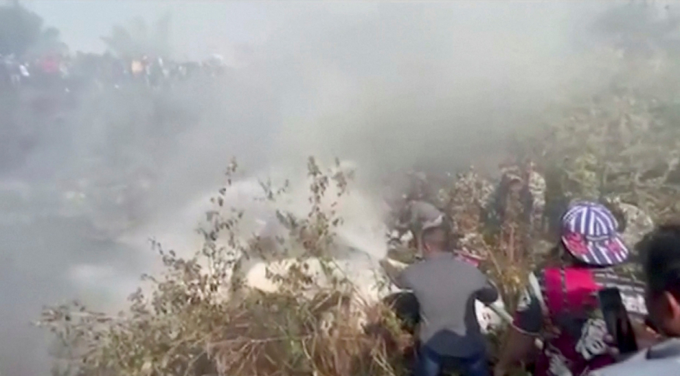 Rescuers work at the site of a plane crash in Pokhra, Nepal January 15, 2023, in this screen grab taken from a handout video. ANI/Handout/via REUTERS  ATTENTION EDITORS - THIS IMAGE HAS BEEN SUPPLIED BY A THIRD PARTY. INDIA OUT. NO COMMERCIAL OR EDITORIAL SALES IN INDIA NEPAL-CRASH/