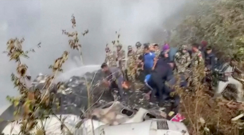 Rescuers work at the site of a plane crash in Pokhara, Nepal January 15, 2023, in this screen grab taken from a handout video. ANI/Handout/via REUTERS  ATTENTION EDITORS - THIS IMAGE HAS BEEN SUPPLIED BY A THIRD PARTY. INDIA OUT. NO COMMERCIAL OR EDITORIAL SALES IN INDIA NEPAL-CRASH/