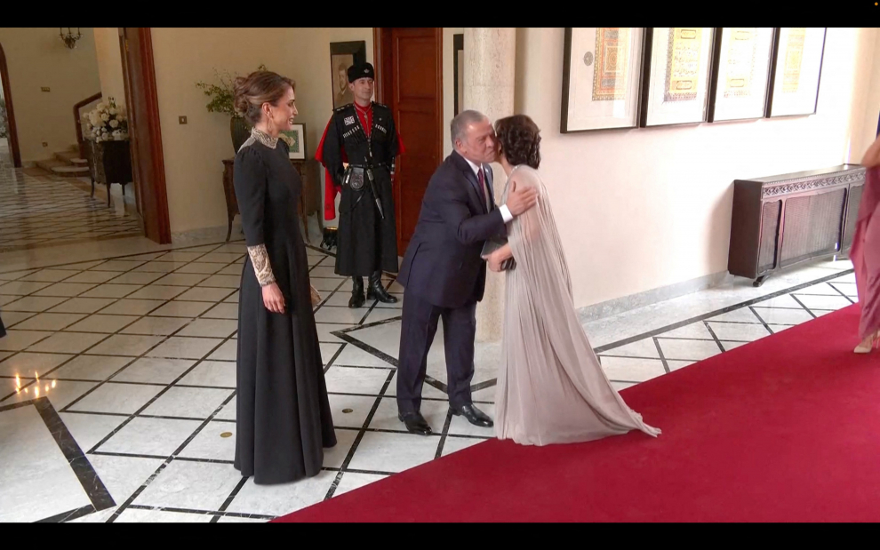 Jordan's King Abdullah II, and Jordan's Queen Rania greet people, on the day of the royal wedding ceremony of Crown Prince Hussein and Rajwa Al Saif, in Amman, Jordan, June 1, 2023 in this screen grab taken from a video. Royal Hashemite Court (RHC)/Handout via REUTERS ATTENTION EDITORS - THIS IMAGE WAS PROVIDED BY A THIRD PARTY. NO RESALES. NO ARCHIVES. JORDAN-ROYALS/WEDDING