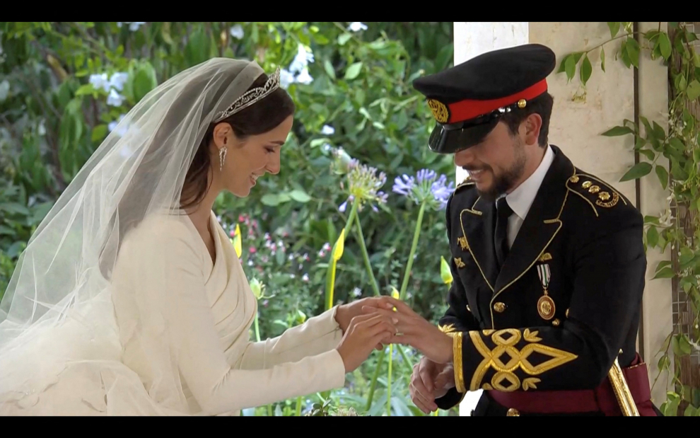 Rajwa Al Said walks with Jordan's Prince Hashem bin Abdullah, on the day of her royal wedding ceremony with Jordan's Crown Prince Hussein, in Amman, Jordan, June 1, 2023 in this screen grab taken from a video. Royal Hashemite Court (RHC)/Handout via REUTERS ATTENTION EDITORS - THIS IMAGE WAS PROVIDED BY A THIRD PARTY. NO RESALES. NO ARCHIVES. JORDAN-ROYALS/WEDDING