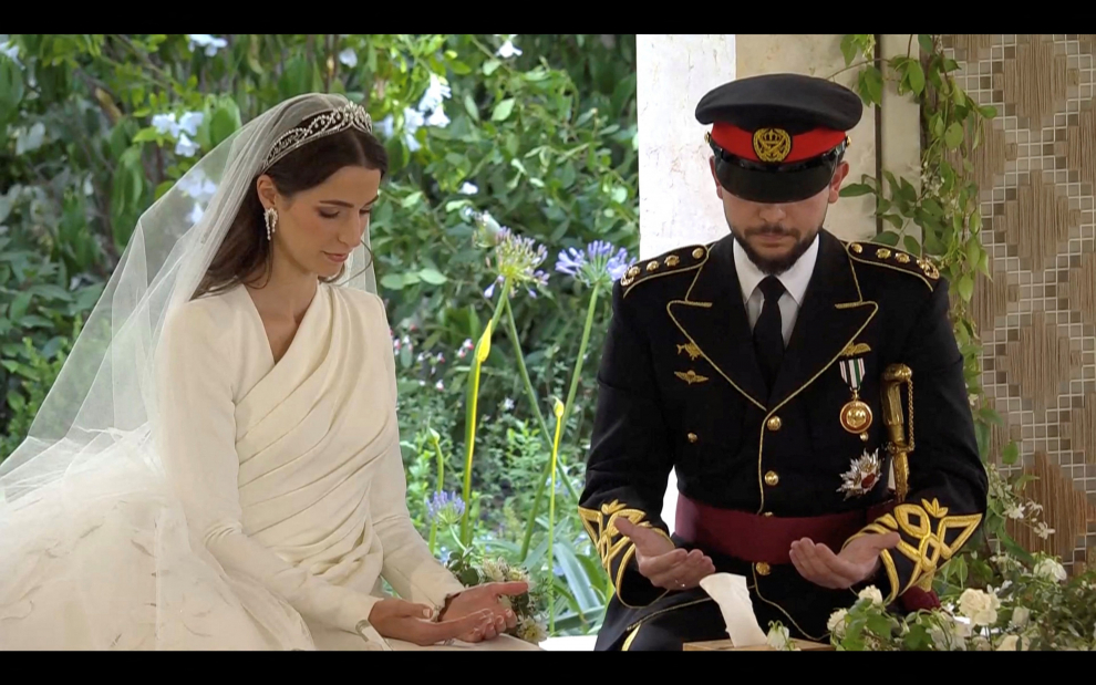 Jordan's Crown Prince Hussein and Rajwa Al Saif exchange rings at their royal wedding ceremony, in Amman, Jordan, June 1, 2023 in this screen grab taken from a video. Royal Hashemite Court (RHC)/Handout via REUTERS ATTENTION EDITORS - THIS IMAGE WAS PROVIDED BY A THIRD PARTY. NO RESALES. NO ARCHIVES. JORDAN-ROYALS/WEDDING