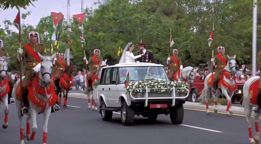 Jordan's Crown Prince Hussein and Rajwa Al Saif leave after their royal wedding ceremony in Amman, Jordan, June 1, 2023 in this screen grab taken from a video. Royal Hashemite Court (RHC)/Handout via REUTERS ATTENTION EDITORS - THIS IMAGE WAS PROVIDED BY A THIRD PARTY. NO RESALES. NO ARCHIVES. REFILE - QUALITY REPEAT JORDAN-ROYALS/WEDDING