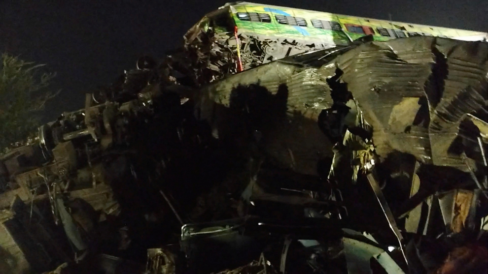 A man uses his phone to take visuals of the damaged coaches, after trains collided in Balasore, India June 3, 2023, in this screen grab obtained from a social media video. Nantu Samui/via REUTERS  THIS IMAGE HAS BEEN SUPPLIED BY A THIRD PARTY. MANDATORY CREDIT. NO RESALES. NO ARCHIVES. INDIA-CRASH/RAIL